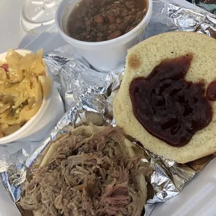 Smoked Pulled Pork Sandwich Dinner with fried cabbage and baked beans