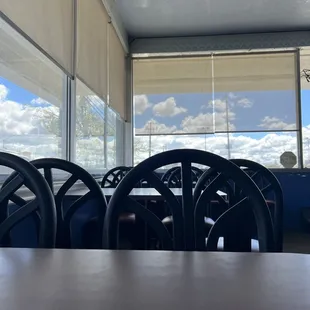a table and chairs in front of a window