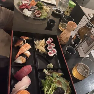 Sushi Omakase closer to camera, ~$29, comes with Miso soup as well. Sapporo and warm sake each $5