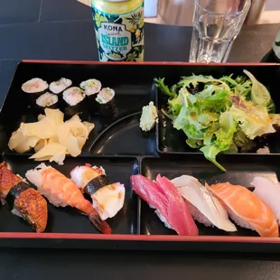 a plate of sushi and salad