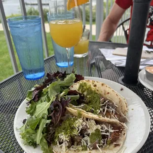Brunch steak tacos with potatoes In the tacos &amp; mixed greens. The drink is a double mimosa!