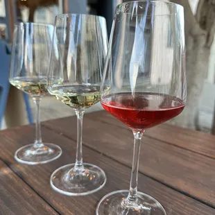 three glasses of wine on a table