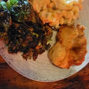 Fried chicken platter. One small fried chicken breast. Healthy portion of macaroni and cheese with sautéed brussel sprouts.