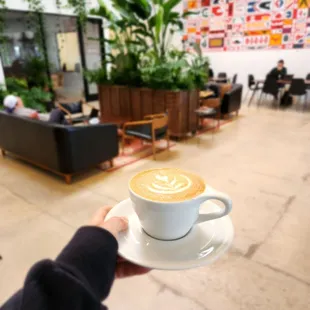 a person holding a cup of coffee