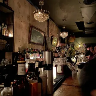 a bar with people sitting at the bar