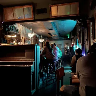 a group of people sitting at a bar