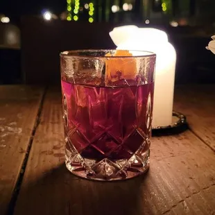 a vase of flowers and a candle on a table