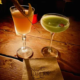 two cocktails on a wooden table