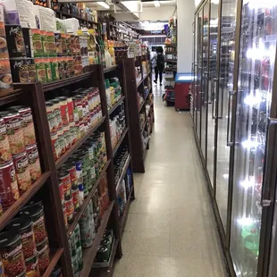a grocery store aisle with shelves full of liquor