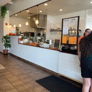 a woman standing in front of a counter
