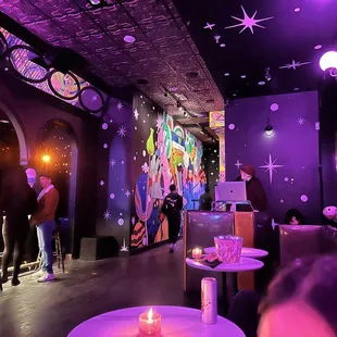 people sitting at tables in a bar