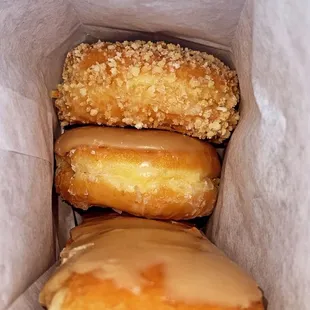 three donuts in a paper bag