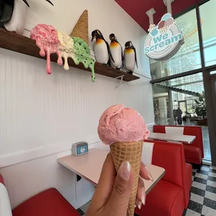 a person holding an ice cream cone