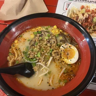 A spicy pork ramen and tuna wonton nachos in the back