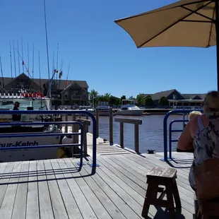 a woman sitting at a table on a dock