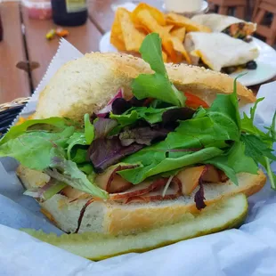 Noreaster. Turkey, avocado, tomato, red onion, greens, creamy bleu cheese dressing.