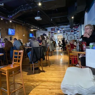 people sitting at tables in a restaurant