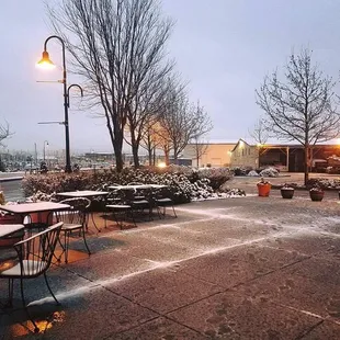 tables and chairs covered in snow