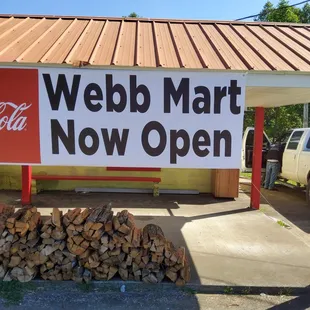 a pile of wood in front of a store