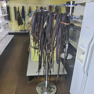 a rack of horse tacks and reins