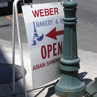 an open sign on a sidewalk