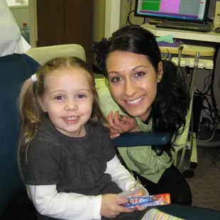 Dental Hygienist posing with a child patient.