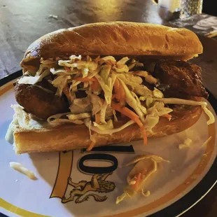 a plate with a sandwich and coleslaw