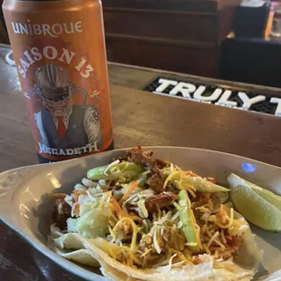 a plate of food and a can of beer