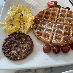 Waffle platter with and my hubby&apos;s two sides were scrambled cheese eggs and sausage.