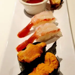 a plate of sushi and shrimp