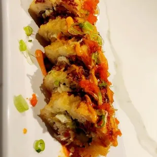 a sushi roll on a white plate