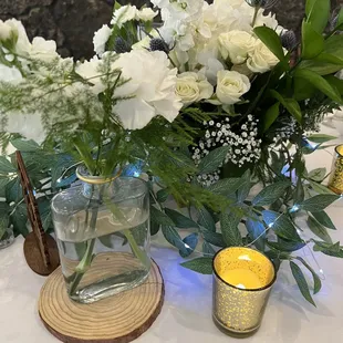 Vases, candle votives, table number, wood rounds-- all rented from WedCycle!