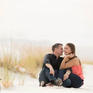 couple sitting during engagement session at White Sands