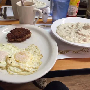 Biscuits and gravy, sausage and eggs over medium