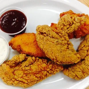 Hot and mild chicken fingers with BBQ sauce and ranch on the side