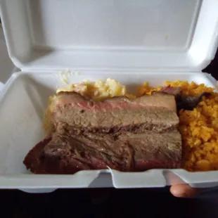 a person holding a styrofoam container
