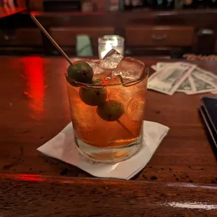 a cocktail with olives