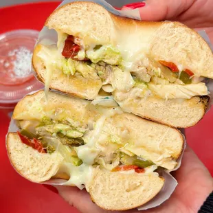 a person holding a sandwich in their hand