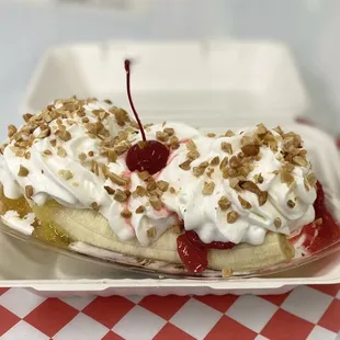 Perfect banana split with strawberries, chocolate topping, pineapples, fresh whipped cream, chopped nuts and a cherry!