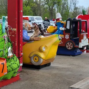 a row of toy cars lined up at a gas station