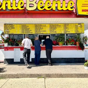 three men standing in front of a store