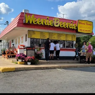 You can see the 2 small picnic tables on the left side of the building.