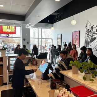 customers at the counter of a coffee shop