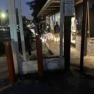 Standing outside because there is no inside.