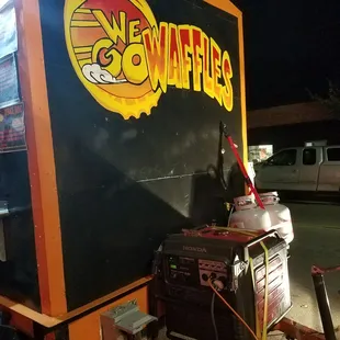 a man standing next to a food truck