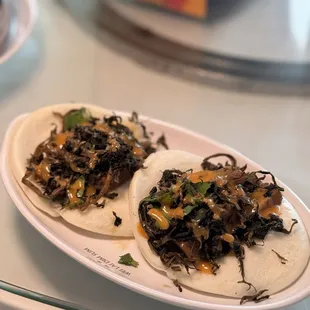 Pork slider - steamed bun with braised pork belly, pickled mustard, cilantro, spicy mayo