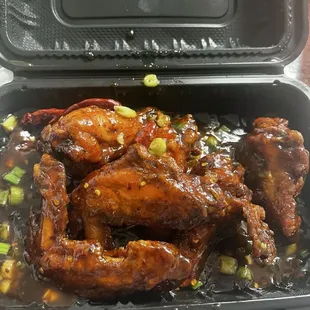 Fried chicken wings tossed in General Tso's sauce.