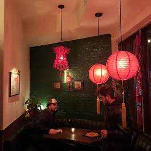 two men sitting at a table in a restaurant