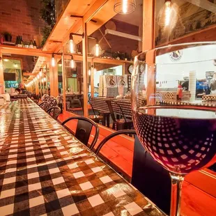 Red wine and cool infinity mirror in warm/cozy interior