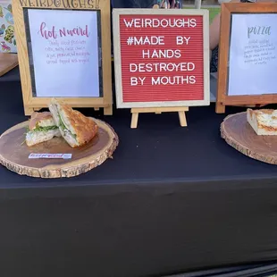 two sandwiches on wooden boards